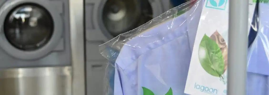 Shirt hanging in front of commercial laundry equipment. Shirt hanging in front of commercial laundry equipment.