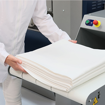 Efficient Commercial Laundry Equipment with Automatic Ironing Machines and Tumble Drying Solutions.