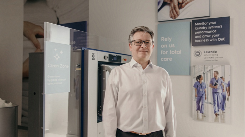 Professional showcasing advanced commercial laundry machines Professional showcasing advanced commercial laundry machines