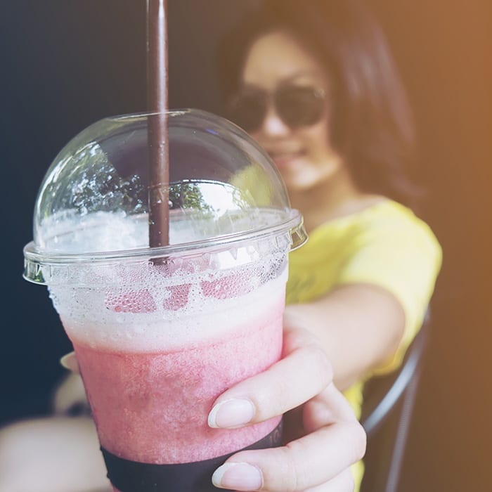 girl holding frozen beverage cup
