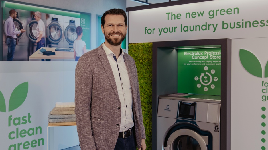 Man standing beside Commercial Washer Machines Man standing beside Commercial Washer Machines