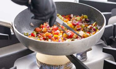 pan with vegetables on cooker