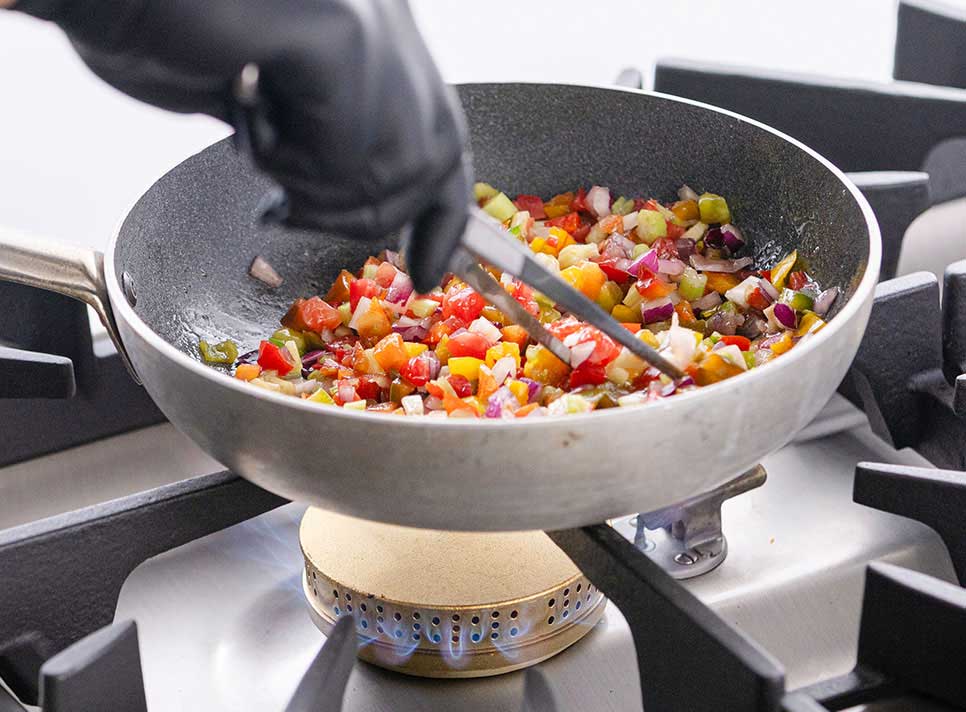 pan with vegetables on cooker