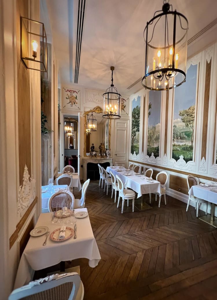 Elegant dining room with chandeliers and set tables inside the hotel restaurant