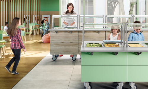 A woman and children at a buffet-style canteen