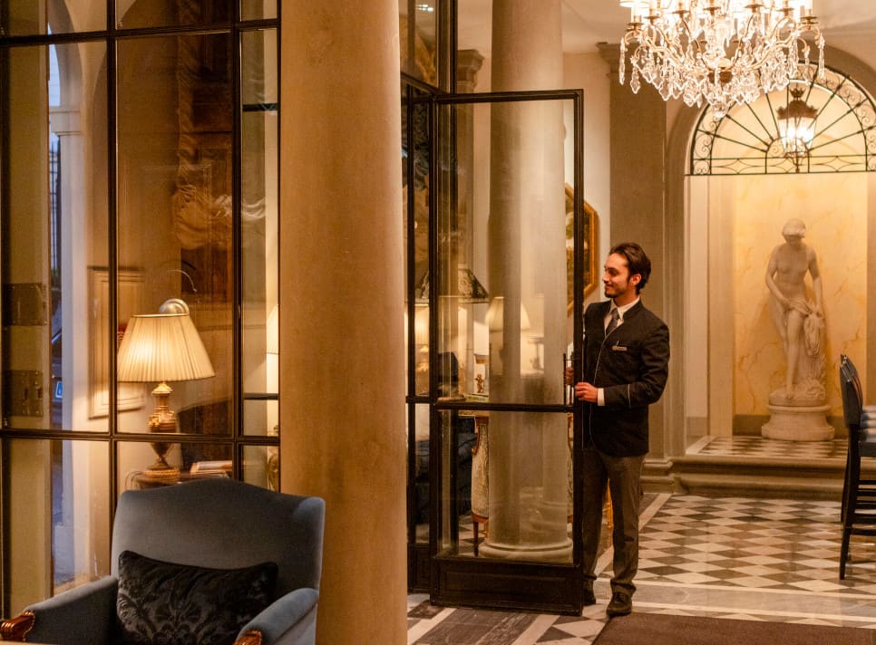 Elegant lobby of luxury hotel with uniformed staff and fine furnishings