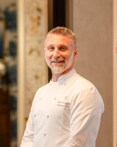 Portrait of chef in uniform at luxury hotel featuring Electrolux Professional kitchen solutions