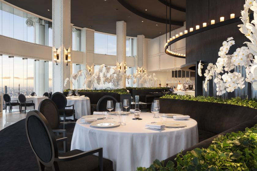 Elegant dining room with round tables and city views at Mezzaluna restaurant in Bangkok